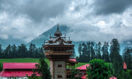 Kullu, Himachal Pradesh, India - August 04, 2018 : Photo of Temple in Green meadows in himalayas,...