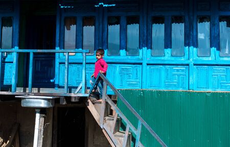 Kullu, Himachal Pradesh, India - September 01, 2018 : Himalayan kid at traditional wooden house in mountain, Indiaのeditorial素材