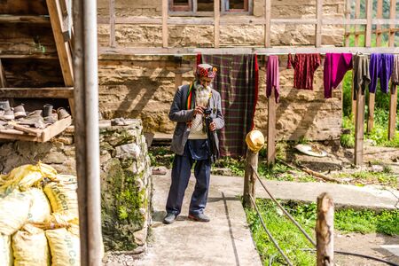 Kullu, Himachal Pradesh, India - September 01, 2018 : Old man Holding Tripod in Village, Himachal, Indiaのeditorial素材