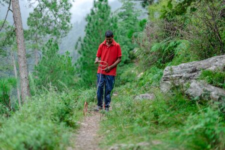 Kullu, Himachal Pradesh, India - September 03, 2018 : boy playing with homemade toy in himalayasのeditorial素材