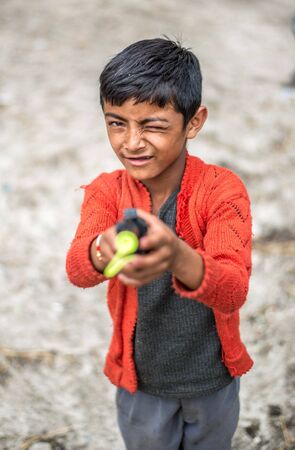Kullu, Himachal Pradesh, India - September 01, 2018 : kid with gun in himalayas, sainjのeditorial素材