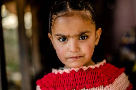 Kullu, Himachal Pradesh, India - April 01, 2019 : Portrait himachali girl near her house on the street in Himalayan village - Indiaのeditorial素材