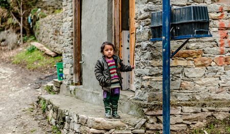 Kullu, Himachal Pradesh, India - April 01, 2019 : Portrait himachali girl near her house on the street in Himalayan village - Indiaのeditorial素材