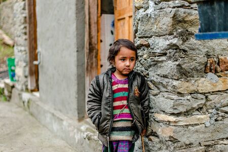 Kullu, Himachal Pradesh, India - April 01, 2019 : Portrait himachali girl near her house on the street in Himalayan village - Indiaのeditorial素材