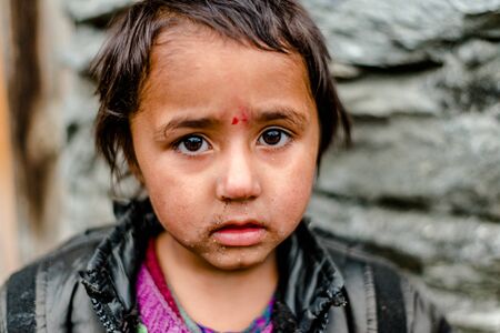 Kullu, Himachal Pradesh, India - April 01, 2019 : Portrait himachali girl near her house on the street in Himalayan village - Indiaのeditorial素材