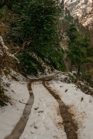 Snow covered road in mountains - Majestic winter landscape in himalayas - Indiaの写真素材