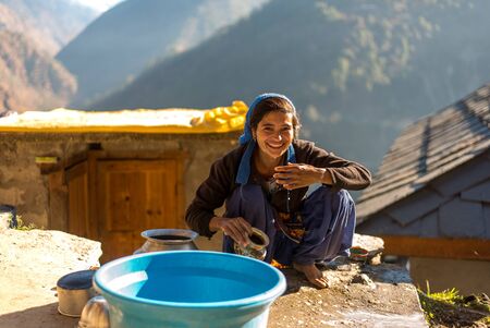 Kullu, Himachal Pradesh, India - December 21, 2018 : Photo of himalayan woman washing her face in mountainsのeditorial素材