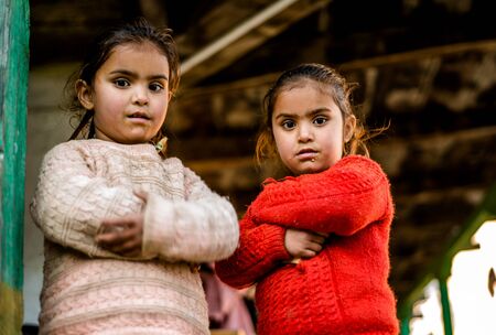 Kullu, Himachal Pradesh, India - December 21, 2018 : poor indian Twins girl child in mountainsのeditorial素材