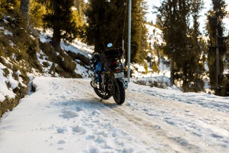 Kullu, Himachal Pradesh, India - January 09, 2019 : Motorcycle ride on winter slippery road in...