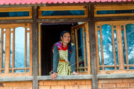 Kullu, Himachal Pradesh, India - January 25, 2019 : himachali woman in traditional dress in her wooden house in winters -のeditorial素材