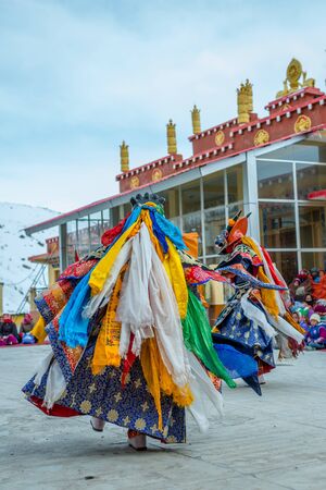 Spiti, Himachal Pradesh, India - March 24, 2019 : Tibetan buddhist lamas dressed in mystical mask dance Tsam mystery in time of festival in himalayasのeditorial素材
