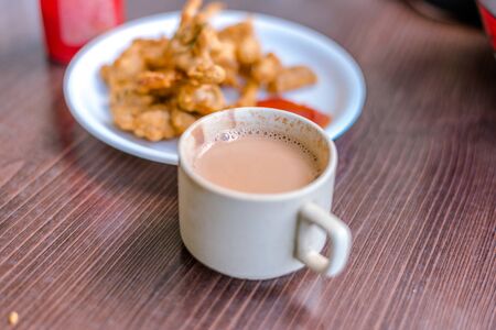 Crispy Kanda bhaji,Pyaj Pakode,fried onion pakoda,onion bhaji with pav or bread.delicious street food,Indian snack in monsoon served with tomato ketchup - Indiaの写真素材
