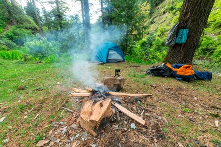 Photo of camping tent at sunset, the camping on the shore of the waterfallの写真素材