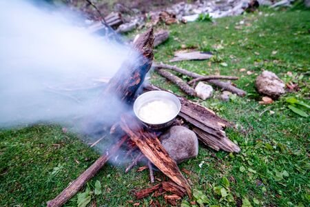 Cooking dinner on wood. Cooking using wood is an survival skill needed when going to the wilderness or outdoor activity.の写真素材
