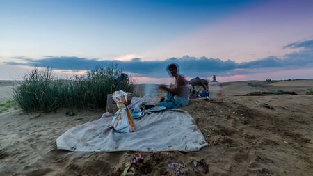 Jaisalmer, Rajasthan, India - July 29, 2019 : Local Man Cooking in Thar Desert -のeditorial素材