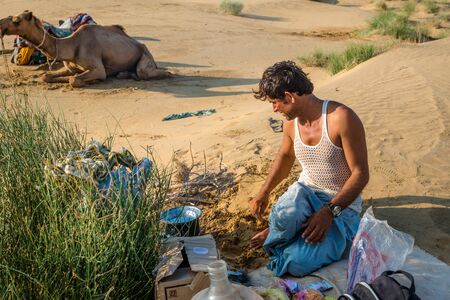 Jaisalmer, Rajasthan, India - July 29, 2019 : Local Man Cooking in Thar Desert -のeditorial素材