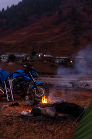 Photo of Motorcycle camping cooking bonfire in arunachalの写真素材