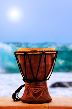 Photo of small brown  tambour with the sea on the backgroundの写真素材