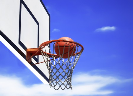 basketball hoop and blue sky in background