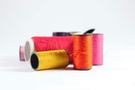 Macro photo of small multi colored spools os threads