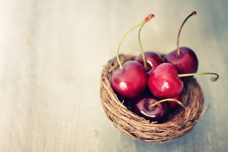 Photo of ripe cherries on wooden backgroundの写真素材