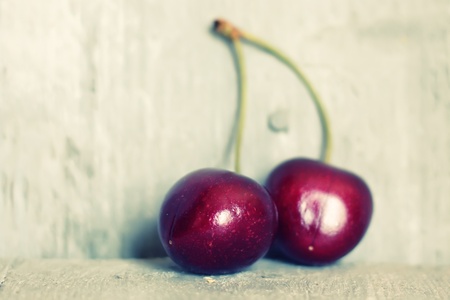 Photo of ripe cherries on wooden backgroundの写真素材
