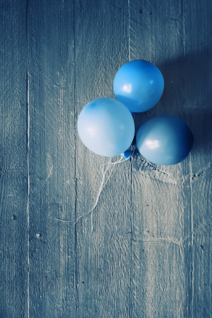 Retro photo of blue air balloons on wooden backgroundの写真素材