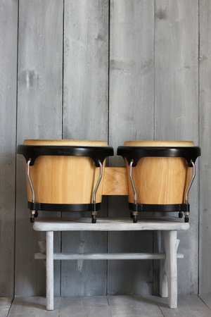 Image of bongo drums with wooden backgroundの写真素材