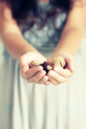 Photo of girl holding nutsの写真素材