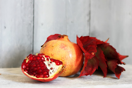 Photo of ripe pomegranate on wooden backgroundの写真素材