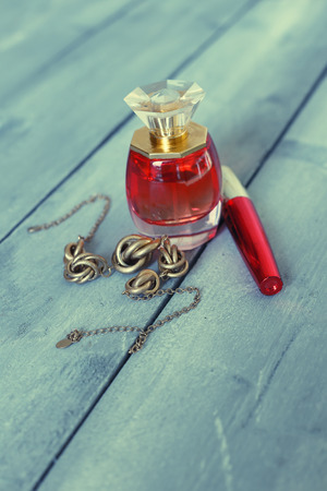 Photo of perfume bottle, necklace and  mascaraの写真素材