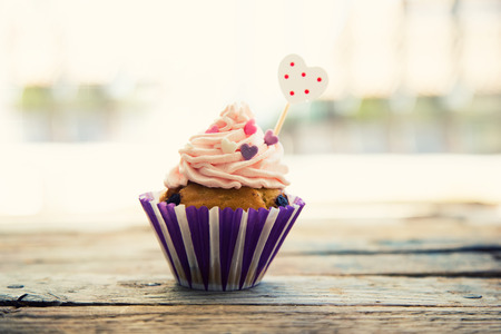 Photo of cute cupcake on wooden backgroundの写真素材