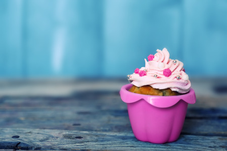 Photo of cute cupcake on wooden background