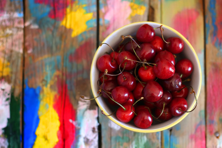 Photo of ripe cherries on wooden backgroundの写真素材