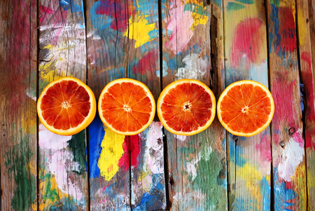 This is a photo of oranges on multi colored backgroundの写真素材