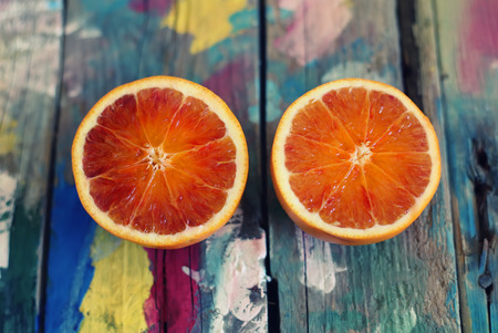This is a photo of oranges on multi colored backgroundの写真素材