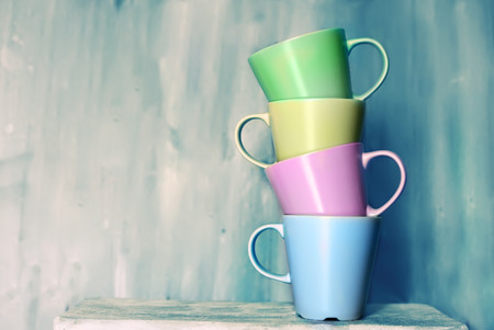 Retro photo of four cute tea  mugsの写真素材