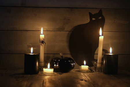 Halloween photo with black pumpkin and candlesの写真素材