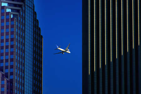 Plane through the skyscrapersのeditorial素材