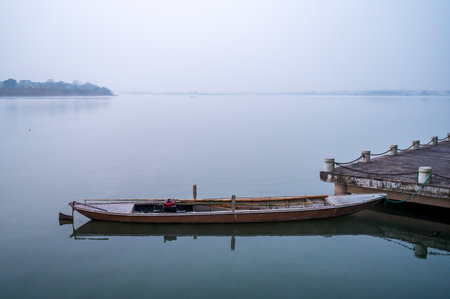 Wooden boat on the lake in foggy day, Thailand.の写真素材