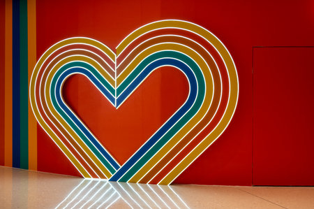 Colorful heart shape on red wall background. Valentine's day concept.