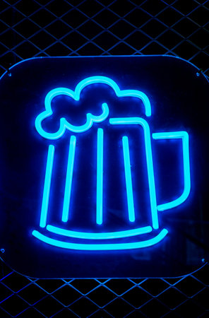 Neon sign of a beer bar on a blue background. Vertical photoの写真素材