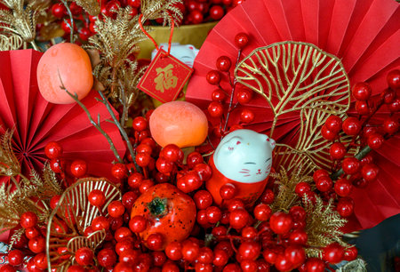 Chinese New Year Decoration with red paper fan and holly berriesの写真素材