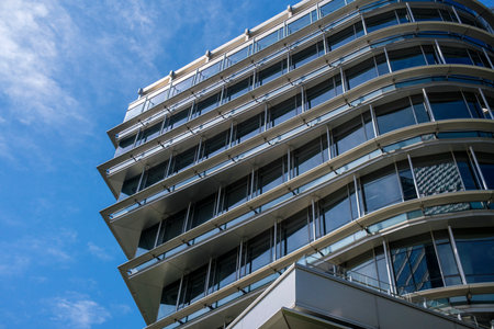 Modern building with blue sky and white clouds, Lisbon, Portugal.