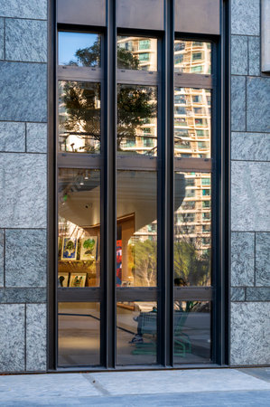 Facade of a modern office building with a reflection in the window