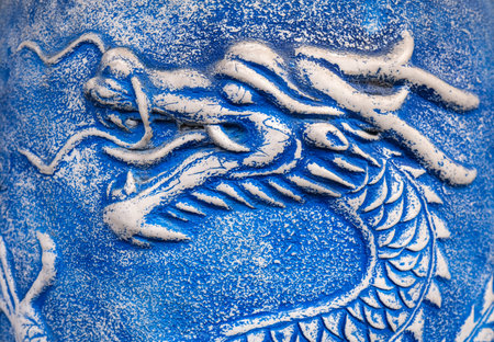 Close-up of a blue Chinese dragon painted on the wall.の写真素材