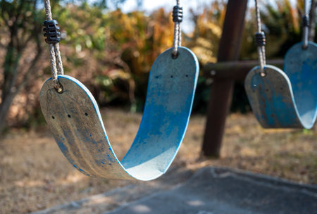 Playground swing in the park with blue sky background, stock photoの写真素材