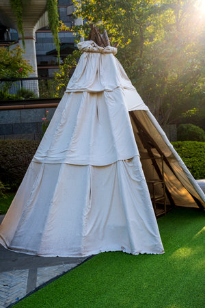 White wigwam for wedding ceremony in the garden on green grassの写真素材