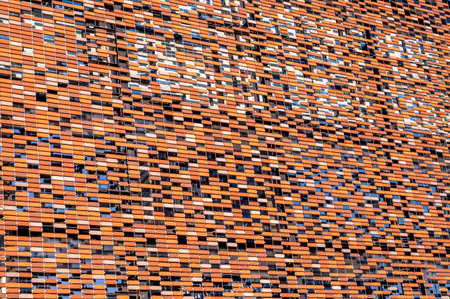 Abstract background of the facade of a modern building in orange and black