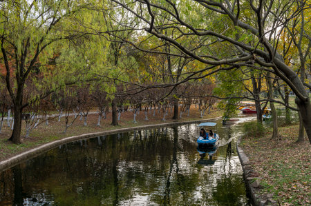 Tourists enjoy a boat ride in the park.の写真素材